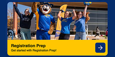 Students outside jumping up happily with Chase Cougar