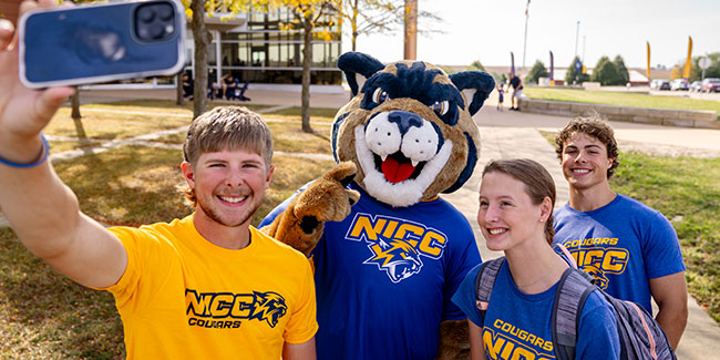 Male and Female students posing outside with Chase