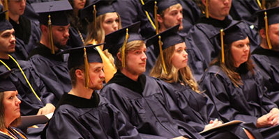 Graduates at the commencement ceremony wearing caps and gowns.