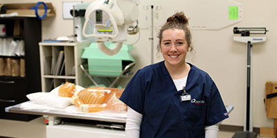 Female Rad Tech student in front of the lab