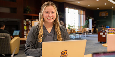 Female student working on her laptop in the Library