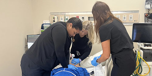 Respiratory care students pratice on patient simulator