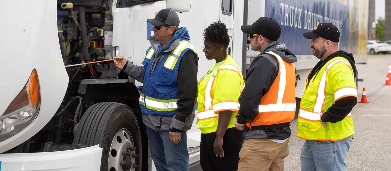 Students work on semitruck
