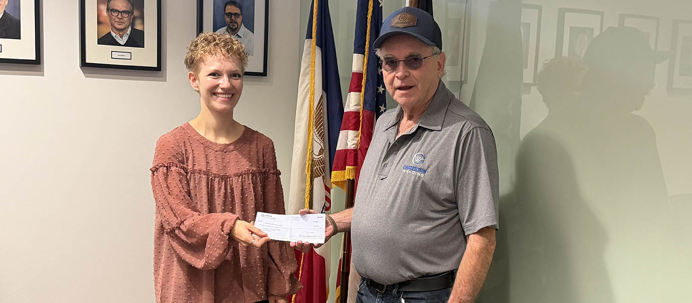 Greg Dougherty gives check to Anna Berns