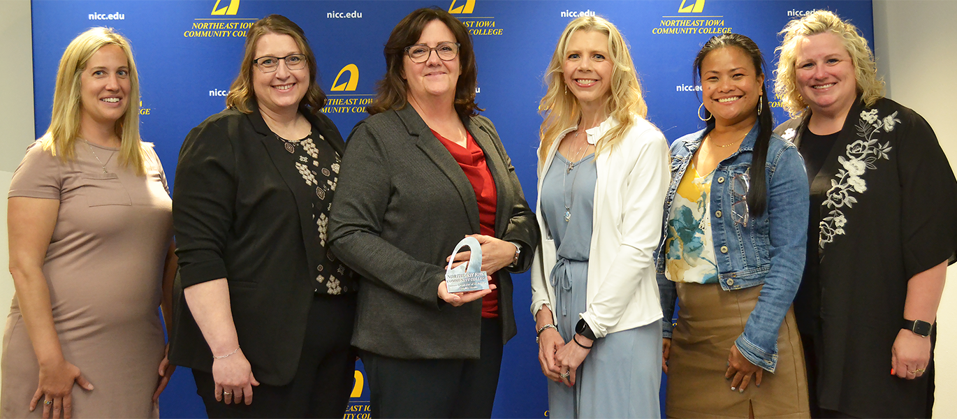 Emplify Health employees pose with Partners in Excellence award