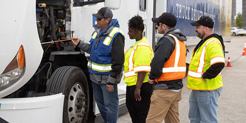 Students work on semitruck