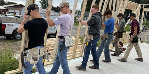 Students frame house