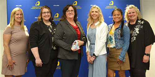 Emplify Health employees pose with Partners in Excellence award