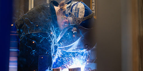 Sparks fly as a student welds