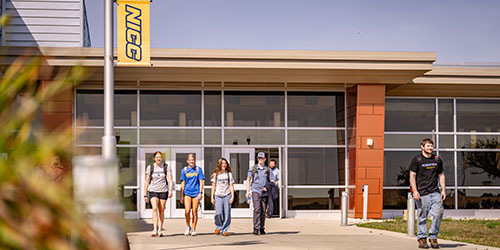 Students walk outside on Peosta campus