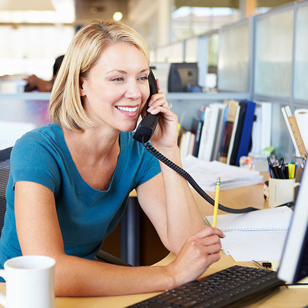 Female professional talking on an office phone