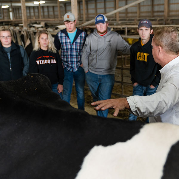 Ag students listening to an instructor in the Dairy barn