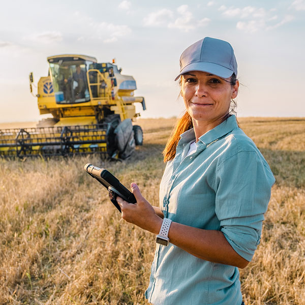 Female farmer in the field with technology