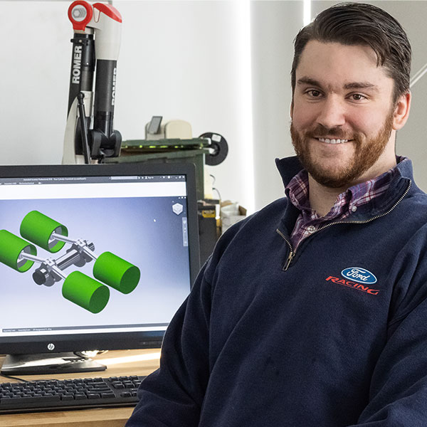 Male student works with an engineering design program on the computer