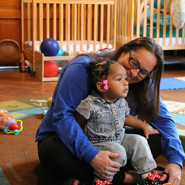 Student posing with a daycare child