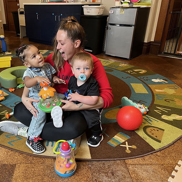 Student posing with daycare kids