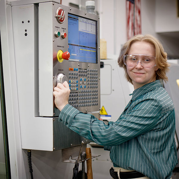 CNC Student works at the panel