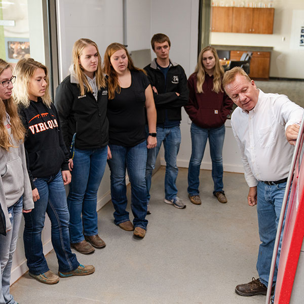 Dairy students listen to an instructor