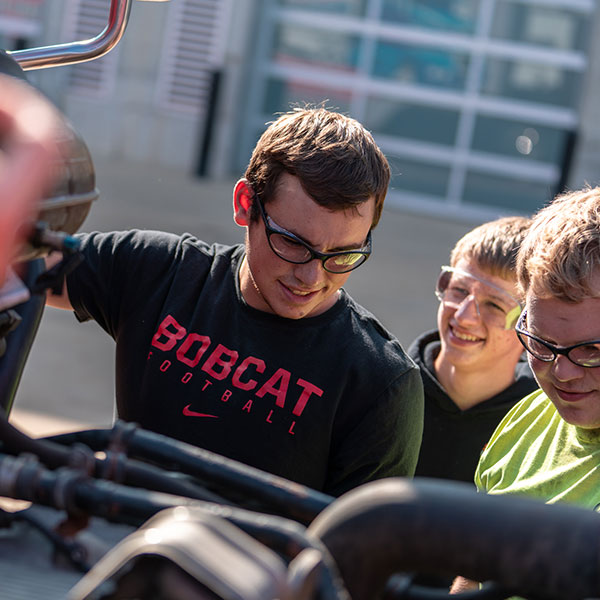 Students check a diesel engine