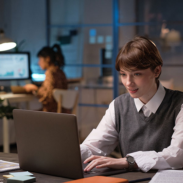 student works on design project on a laptop