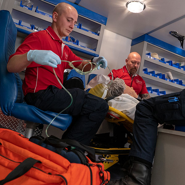 EMT students working on dummy in rig