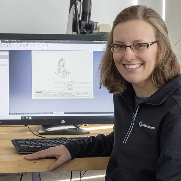 Female engineering student poses in front of her computer work