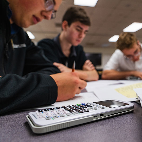 Students doing homework with a calculator