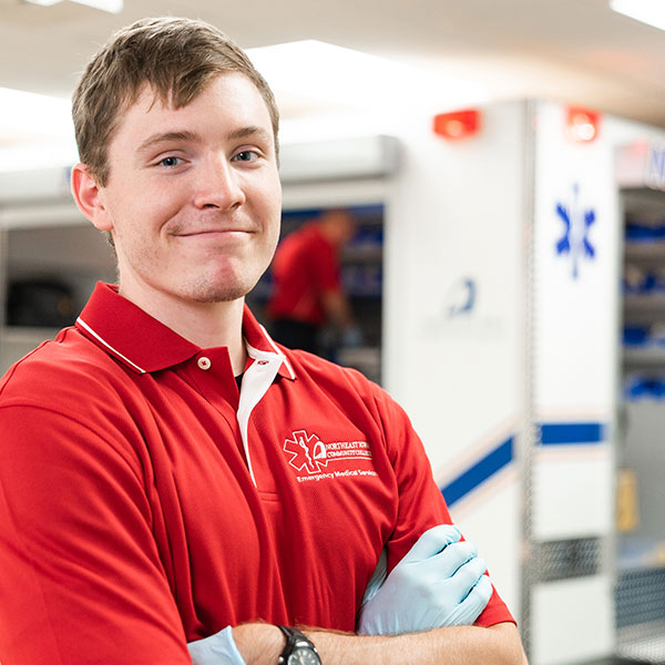 EMT paramedic student posing in front of the NICC EMT lab