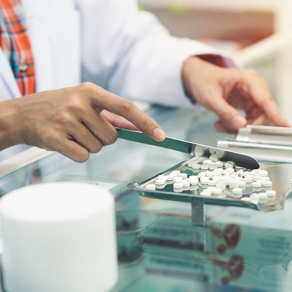 Pharmacist counting pills