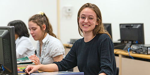 An accountant assists a couple at her desk.