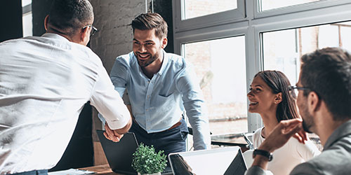 Sales man giving a pitch to a room of people