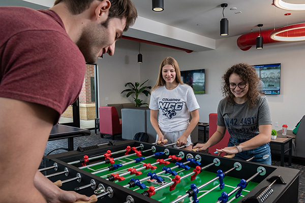 students playing games in the Rec Room in College Suites