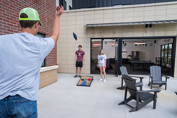 students playing games in the outdoor space at College Suites